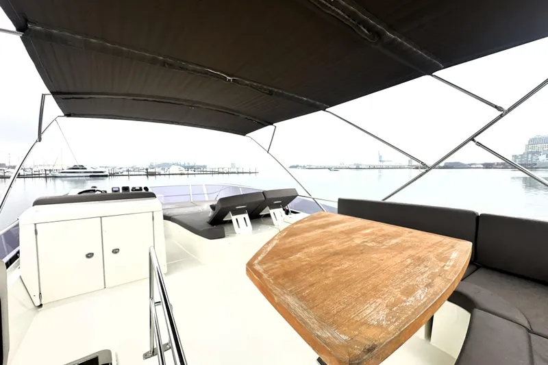 Cyctrade Yacht Photos Pics 2017 Prestige 500 yacht deck with seating, table, and canopy, docked at marina.