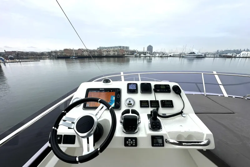 Cyctrade Yacht Photos Pics Helm of 2017 Prestige 500 yacht with navigation controls, overlooking marina.