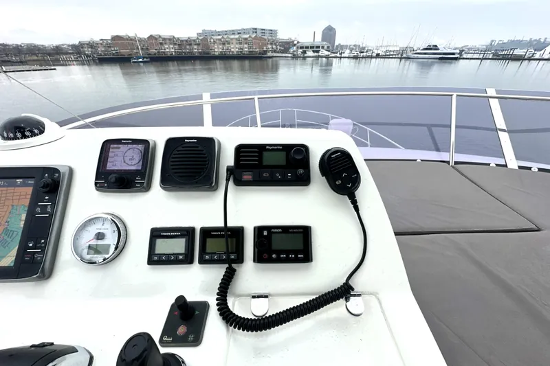 Cyctrade Yacht Photos Pics Control panel of a 2017 Prestige 500 yacht overlooking a marina.
