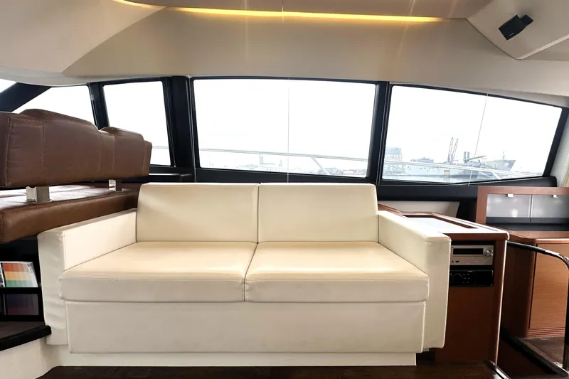 Cyctrade Yacht Photos Pics Luxurious interior of 2017 Prestige 500 yacht with white leather seating and panoramic windows.