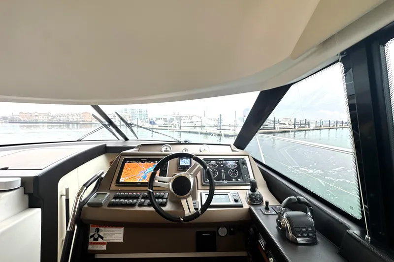 Cyctrade Yacht Photos Pics Interior view of 2017 Prestige 500 yacht cockpit with navigation controls and steering wheel.