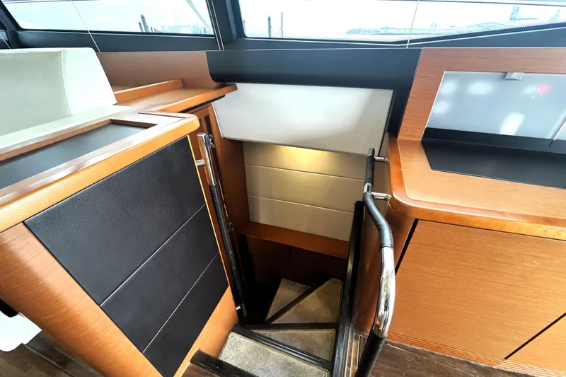 Cyctrade Yacht Photos Pics Interior stairs of a 2017 Prestige 500 yacht, featuring sleek wood and leather finishes.
