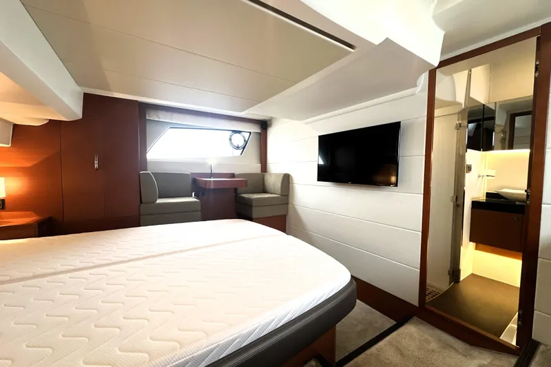 Cyctrade Yacht Photos Pics Luxurious 2017 Prestige 500 yacht interior with bed, seating, TV, and bathroom.
