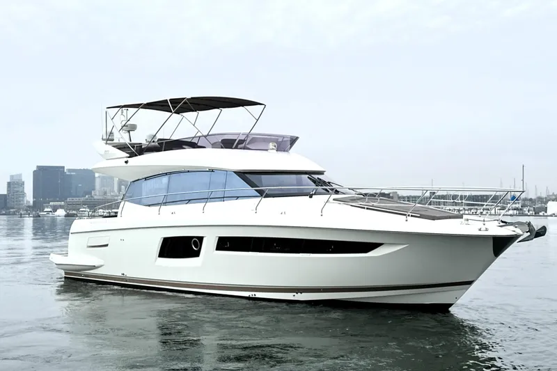 Cyctrade Yacht Photos Pics 2017 Prestige 500 yacht on calm water with city skyline backdrop.