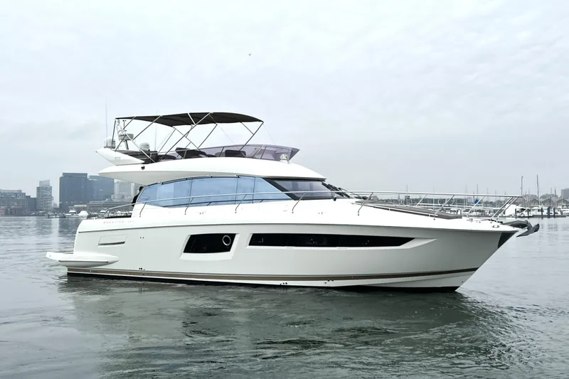 Cyctrade Yacht Photos Pics 2017 Prestige 500 yacht on calm water with city skyline in background.