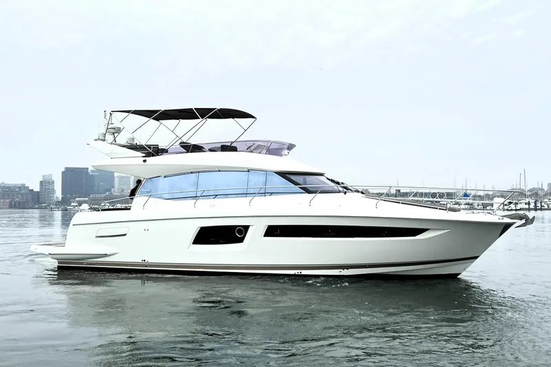 Cyctrade Yacht Photos Pics 2017 Prestige 500 yacht on calm water with city skyline in background.