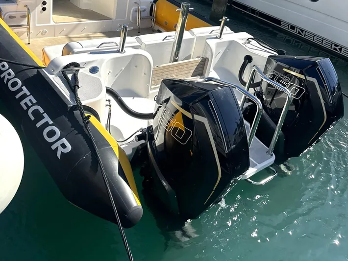 Lizzie Yacht Photos Pics 2020 Protector TARGA 380 boat with dual outboard engines docked in marina.