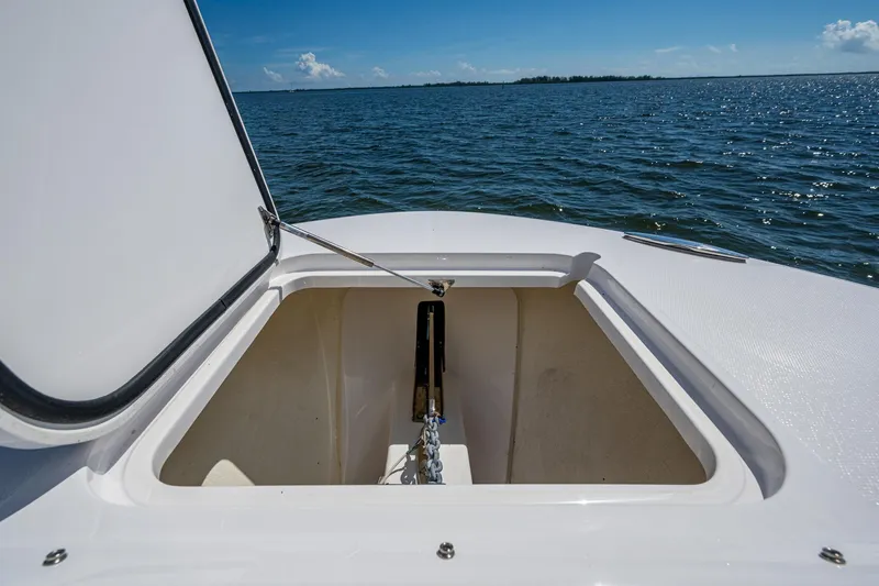  Yacht Photos Pics Open anchor compartment on 2022 Southport 33 DC boat, ocean view in background.