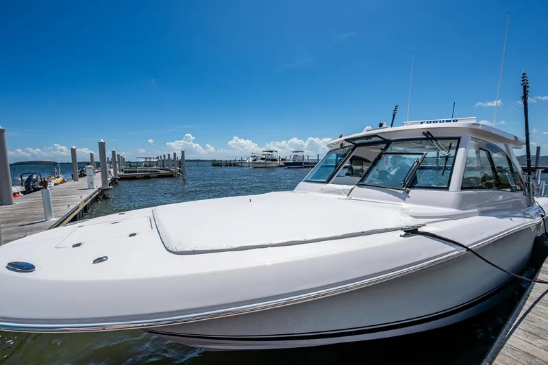  Yacht Photos Pics 2022 Southport 33 DC boat docked under clear blue sky.
