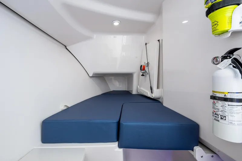  Yacht Photos Pics 2022 Southport 33 DC cabin interior with blue cushions and safety equipment.