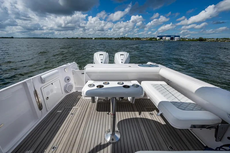  Yacht Photos Pics 2022 Southport 33 DC boat interior with seating and table on open water.