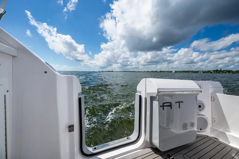  Yacht Photos Pics 2022 Southport 33 DC boat on open water under a partly cloudy sky.