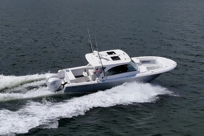  Yacht Photos Pics 2022 Southport 33 DC boat cruising on open water, showcasing sleek design and powerful engines.