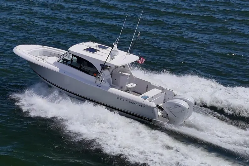  Yacht Photos Pics 2022 Southport 33 DC boat cruising on open water, showcasing sleek design and powerful engines.