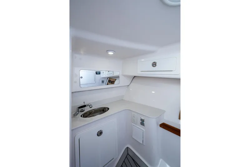  Yacht Photos Pics Interior of 2022 Southport 33 DC boat featuring sleek white cabinetry and sink.