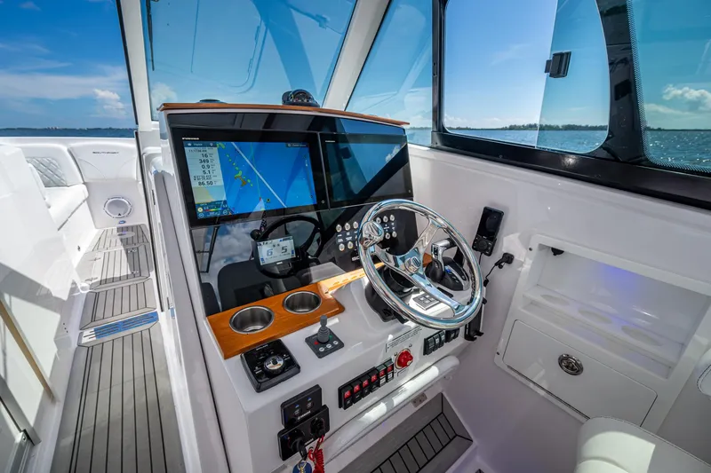  Yacht Photos Pics 2022 Southport 33 DC boat helm with modern navigation system and ocean view.