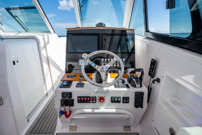  Yacht Photos Pics Cockpit of 2022 Southport 33 DC boat with modern steering and controls.