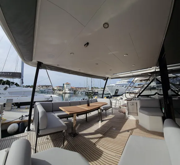 Diamond Si Yacht Photos Pics Luxurious 2024 Prestige M48 yacht deck with seating and table, docked at marina.