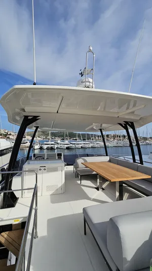 Diamond Si Yacht Photos Pics 2024 Prestige M48 yacht with spacious deck and seating, docked at marina under blue sky.
