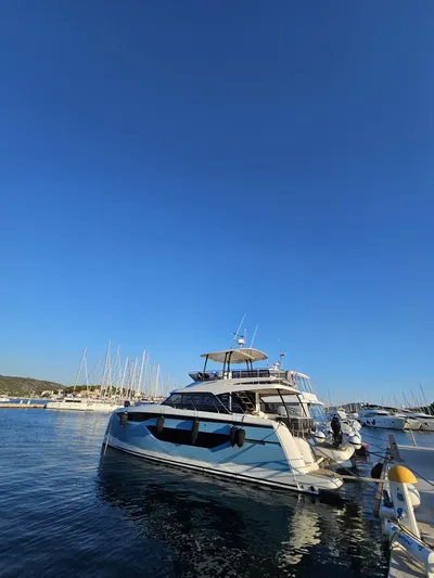 Diamond Si Yacht Photos Pics 2024 Prestige M48 yacht docked in a serene marina under a clear blue sky.