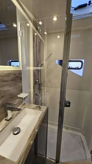 Diamond Si Yacht Photos Pics Modern bathroom in 2024 Prestige M48 yacht with sleek fixtures and glass shower.