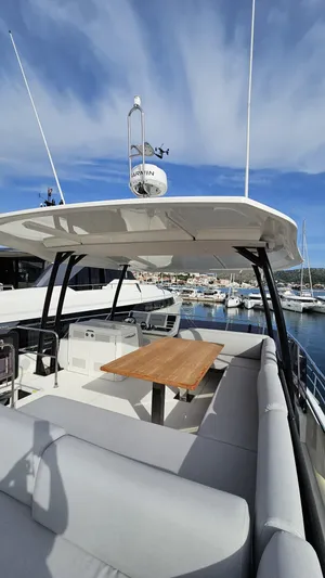 Diamond Si Yacht Photos Pics 2024 Prestige M48 yacht with spacious deck and seating, docked at a marina under a blue sky.