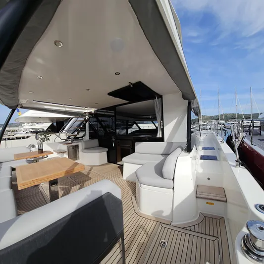 Diamond Si Yacht Photos Pics Luxurious 2024 Prestige M48 yacht deck with elegant seating and dining area.