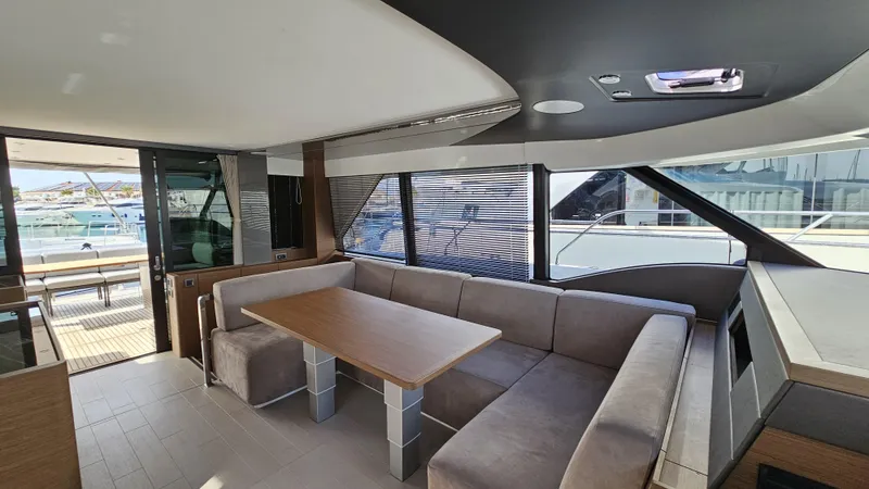 Diamond Si Yacht Photos Pics Luxurious interior of 2024 Prestige M48 yacht with modern seating and dining area.