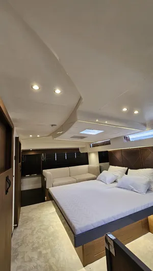 Diamond Si Yacht Photos Pics Luxurious interior of 2024 Prestige M48 yacht with modern lighting and comfortable bedding.
