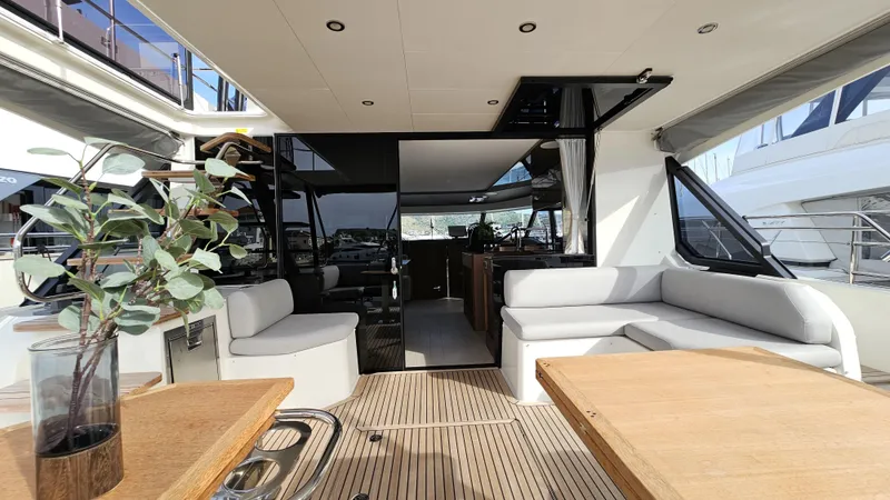 Diamond Si Yacht Photos Pics Luxurious 2024 Prestige M48 yacht interior with elegant seating and wooden accents.