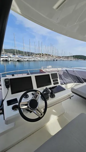 Diamond Si Yacht Photos Pics 2024 Prestige M48 yacht helm with dual screens, overlooking marina and sailboats.