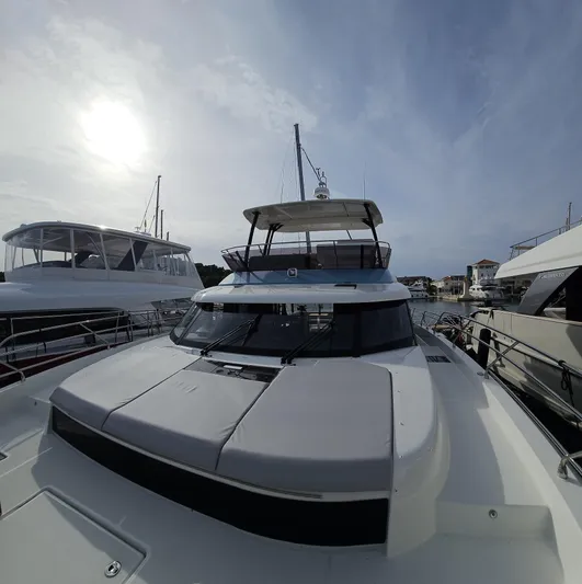 Diamond Si Yacht Photos Pics 2024 Prestige M48 yacht docked under a cloudy sky, showcasing sleek design and modern features.