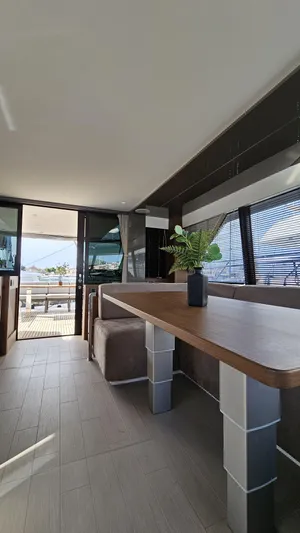 Diamond Si Yacht Photos Pics Luxurious interior of 2024 Prestige M48 yacht with modern dining area and scenic view.