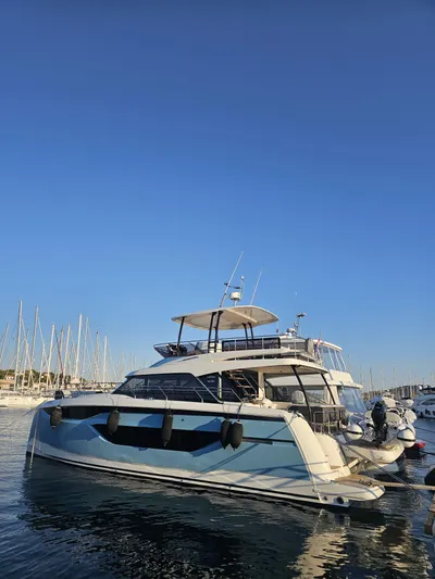 Diamond Si Yacht Photos Pics 2024 Prestige M48 yacht docked in a marina under clear blue skies.