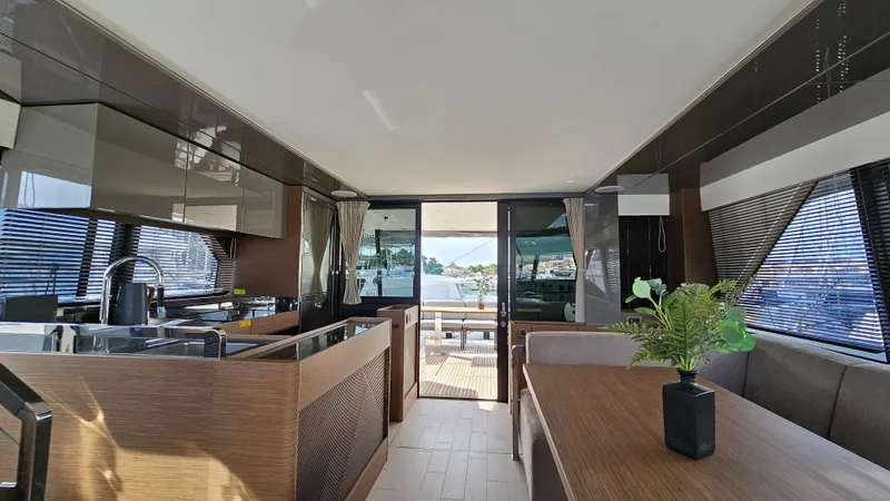 Diamond Si Yacht Photos Pics Luxurious interior of 2024 Prestige M48 yacht with modern kitchen and dining area.