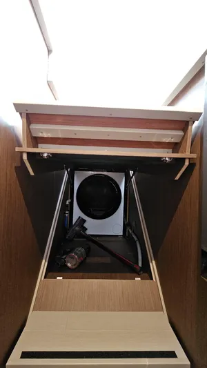 Diamond Si Yacht Photos Pics 2024 Prestige M48 interior storage compartment with built-in appliance and wooden shelving.