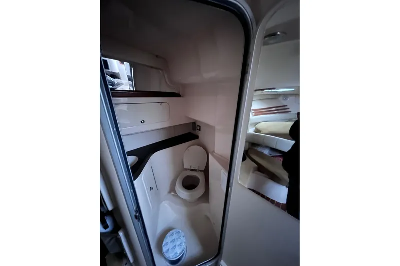  Yacht Photos Pics 2007 Grady-White Express 330 boat interior with compact bathroom and sleeping area.