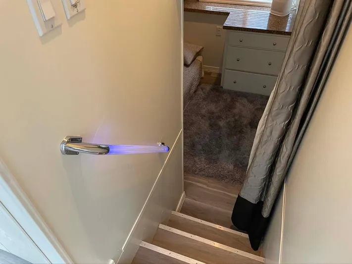 While It Lasts Yacht Photos Pics Staircase with illuminated door handle leading to cozy room, Thoroughbred 6516, 2004.