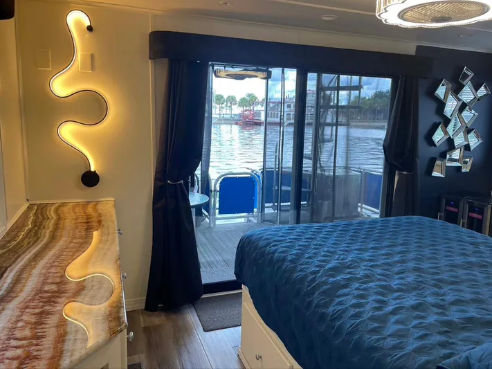 While It Lasts Yacht Photos Pics Luxurious houseboat bedroom with river view, modern lighting, and elegant decor. Thoroughbred 6516, 2004.