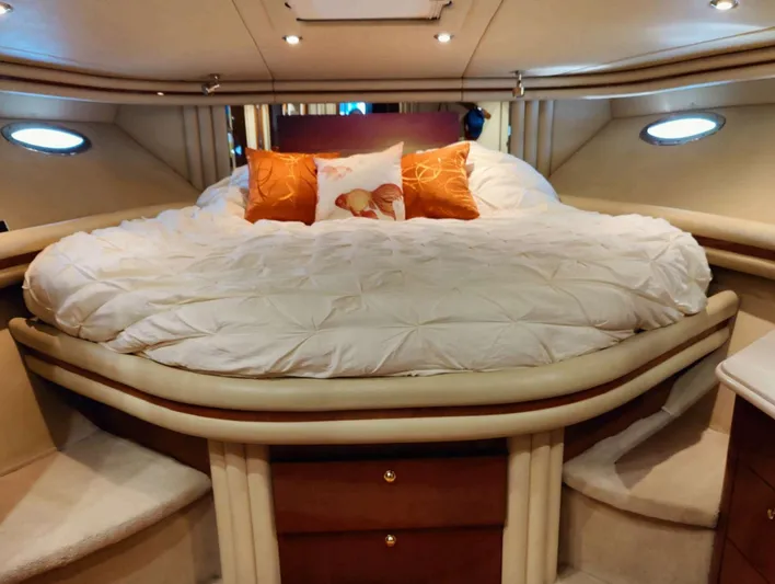 Wade N Winda Yacht Photos Pics Luxurious bedroom interior of 1999 Sea Ray 560 Sedan Bridge yacht with plush bedding.