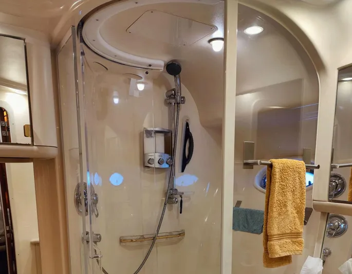 Wade N Winda Yacht Photos Pics Shower area in 1999 Sea Ray 560 Sedan Bridge yacht with glass door and towel rack.