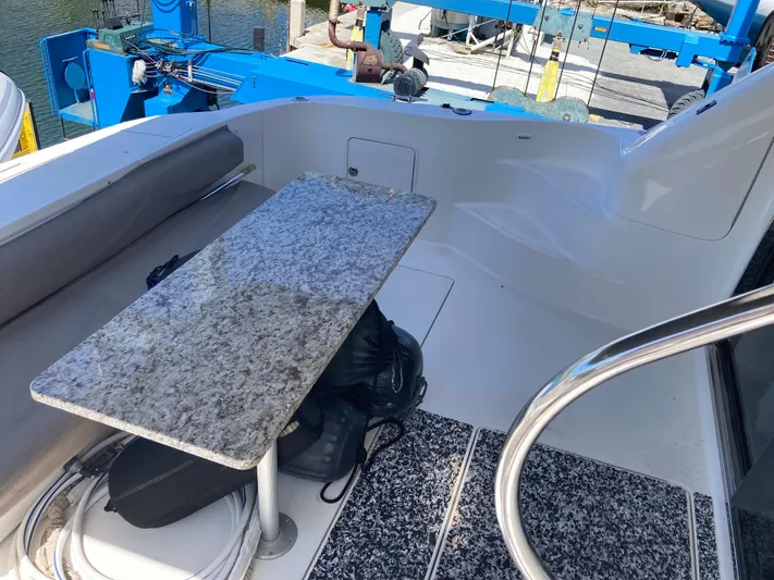 Wade N Winda Yacht Photos Pics 1999 Sea Ray 560 Sedan Bridge yacht with granite table and seating area.