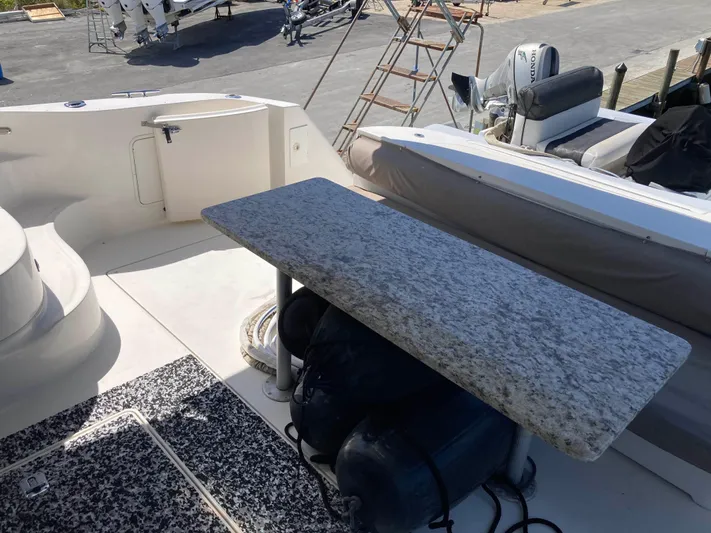 Wade N Winda Yacht Photos Pics 1999 Sea Ray 560 Sedan Bridge yacht deck with granite table and seating area.