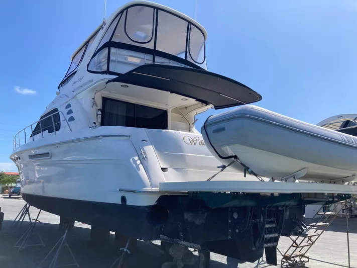 Wade N Winda Yacht Photos Pics 1999 Sea Ray 560 Sedan Bridge yacht on dry dock with inflatable boat.
