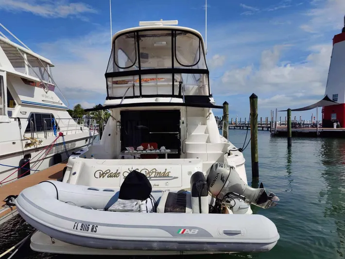 Wade N Winda Yacht Photos Pics 1999 Sea Ray 560 Sedan Bridge yacht docked with inflatable boat attached.