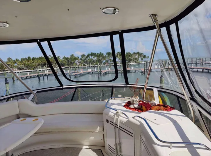 Wade N Winda Yacht Photos Pics Interior view of 1999 Sea Ray 560 Sedan Bridge yacht with marina backdrop.