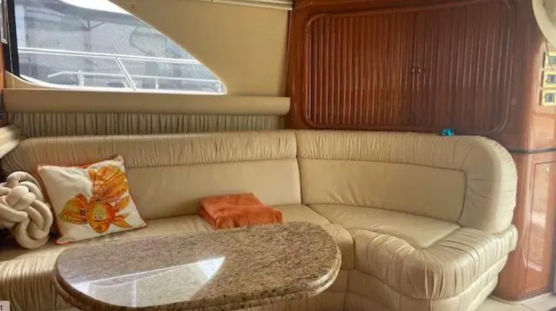 Wade N Winda Yacht Photos Pics Luxurious interior of 1999 Sea Ray 560 Sedan Bridge with plush seating and elegant decor.