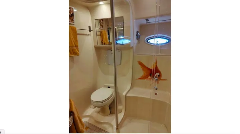 Wade N Winda Yacht Photos Pics Bathroom interior of 1999 Sea Ray 560 Sedan Bridge yacht with shower and porthole.