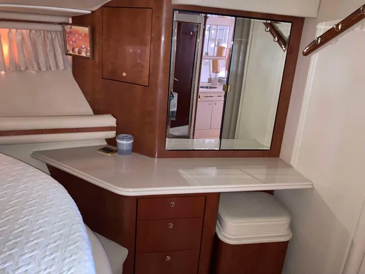 Wade N Winda Yacht Photos Pics 1999 Sea Ray 560 Sedan Bridge interior with vanity, mirror, and storage drawers.