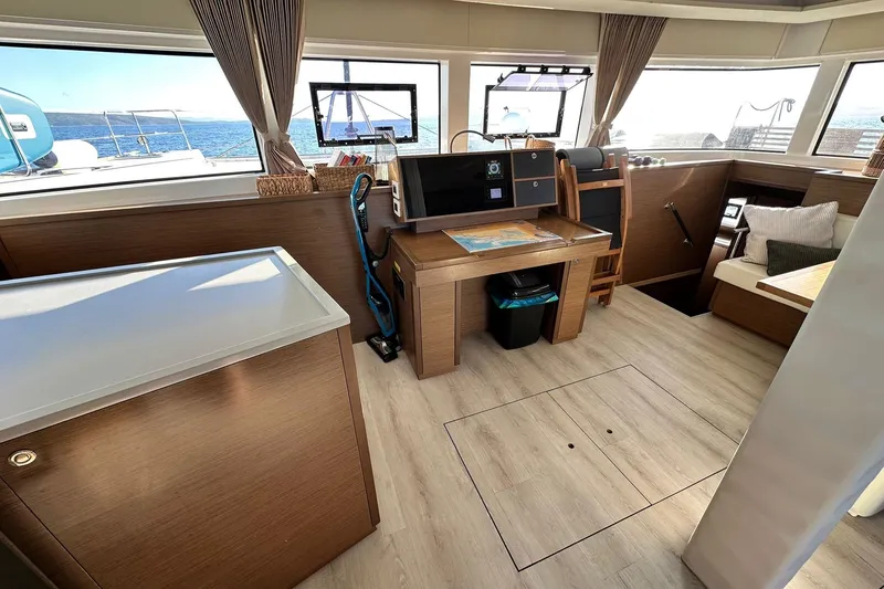  Yacht Photos Pics Interior of 2019 Lagoon 52 F yacht with modern wood finish and ocean view.